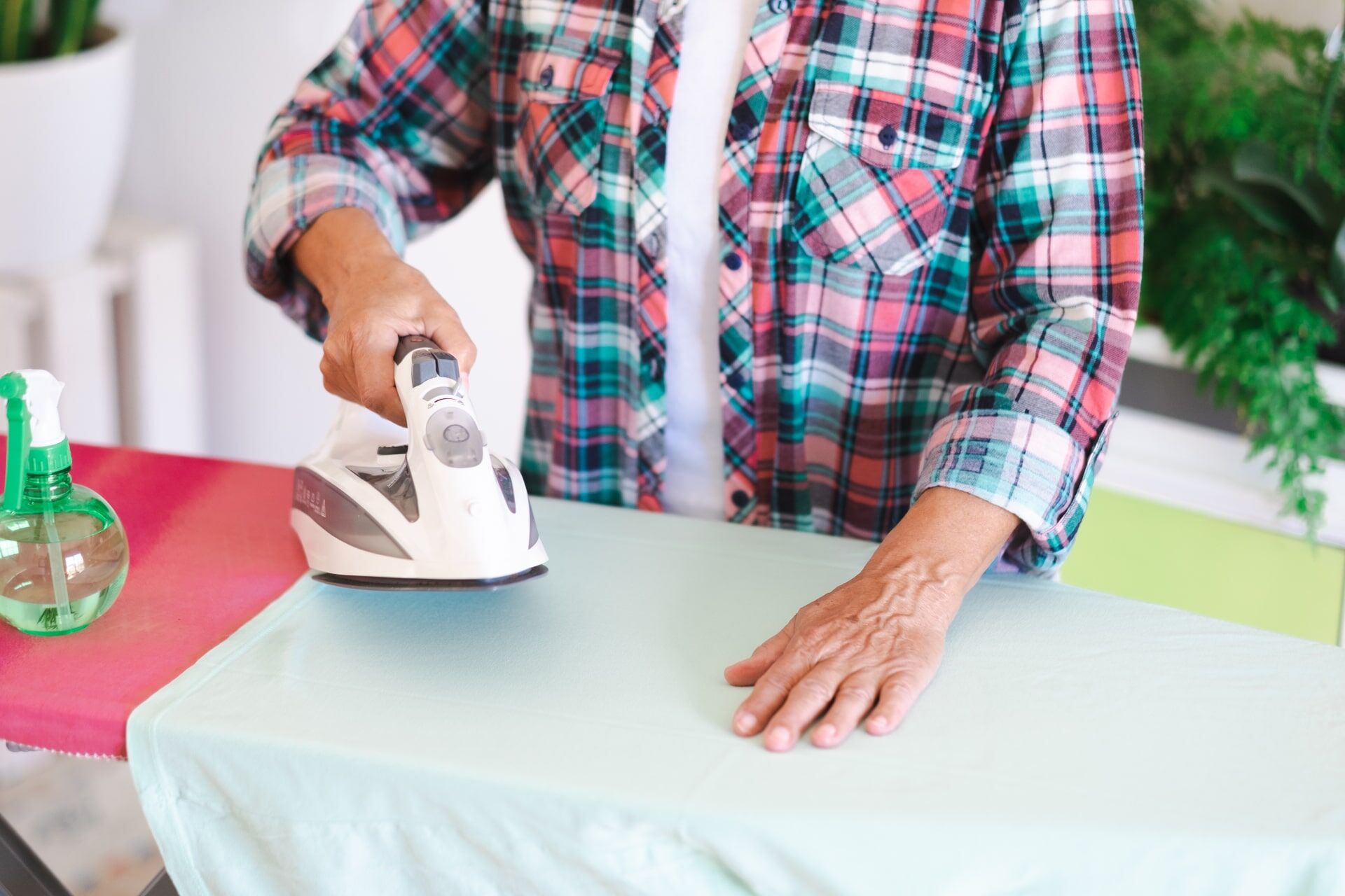 closeup-of-mature-woman-in-checkered-shirt-ironing-2024-11-02-23-29-41-utc-min.jpg